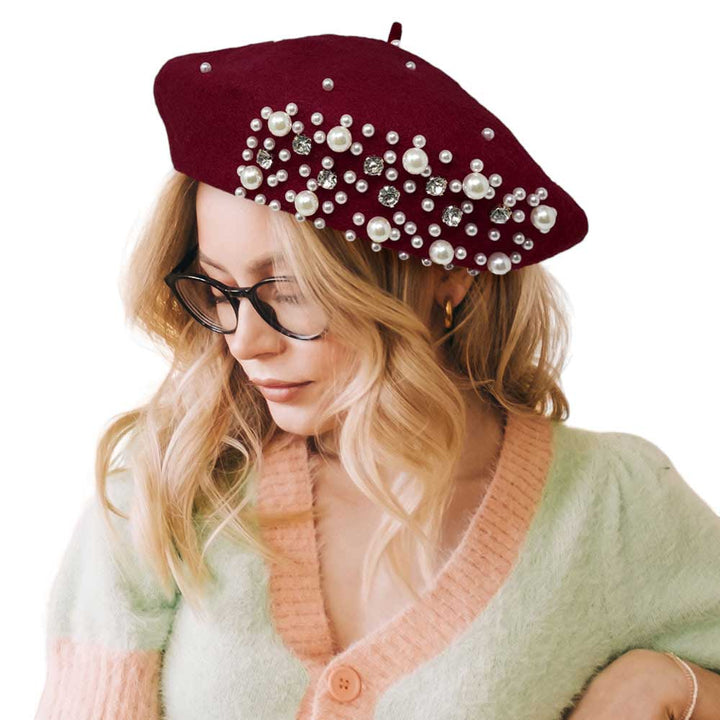 Burgundy Pearl Stone Embellished Solid Beret Hat, this timeless pearl stone beret hat is a luxurious accessory for any wardrobe. Crafted from a quality fabric, it's adorned with shimmering pearl stones that will add a touch of opulence to any outfit. Perfect gift item for Birthdays, Christmas, Secret Santa, and anniversaries.