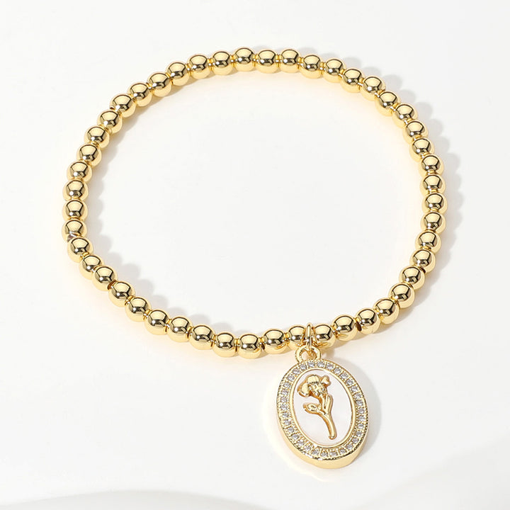 Gold, Mother of Pearl Stainless Steel Stone Paved Tulip Flower Embossed Mother of Pearl Oval Charm Beaded Stretch Bracelet