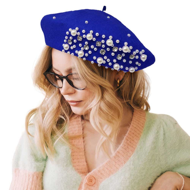 Royal Blue Pearl Stone Embellished Solid Beret Hat, this timeless pearl stone beret hat is a luxurious accessory for any wardrobe. Crafted from a quality fabric, it's adorned with shimmering pearl stones that will add a touch of opulence to any outfit. Perfect gift item for Birthdays, Christmas, Secret Santa, and anniversaries.