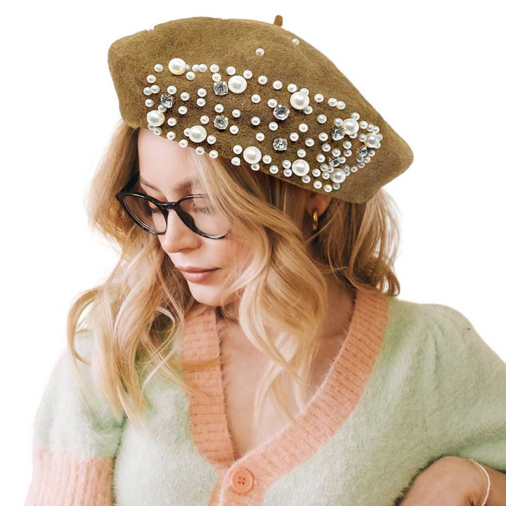 Tan Pearl Stone Embellished Solid Beret Hat, this timeless pearl stone beret hat is a luxurious accessory for any wardrobe. Crafted from a quality fabric, it's adorned with shimmering pearl stones that will add a touch of opulence to any outfit. Perfect gift item for Birthdays, Christmas, Secret Santa, and anniversaries.