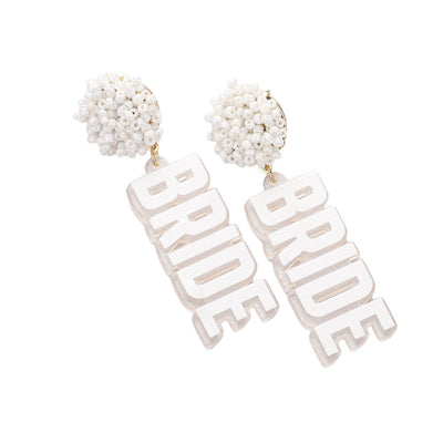 White Pearl Beaded Cluster Sparkle Resin BRIDE Message Dangle Earrings, these earrings will add a touch of sparkle and sophistication to any bridal outfit. The pearl beads and resin materials create a beautiful cluster design, while the "BRIDE" message adds a special touch. Perfect for any bride looking to make a statement.